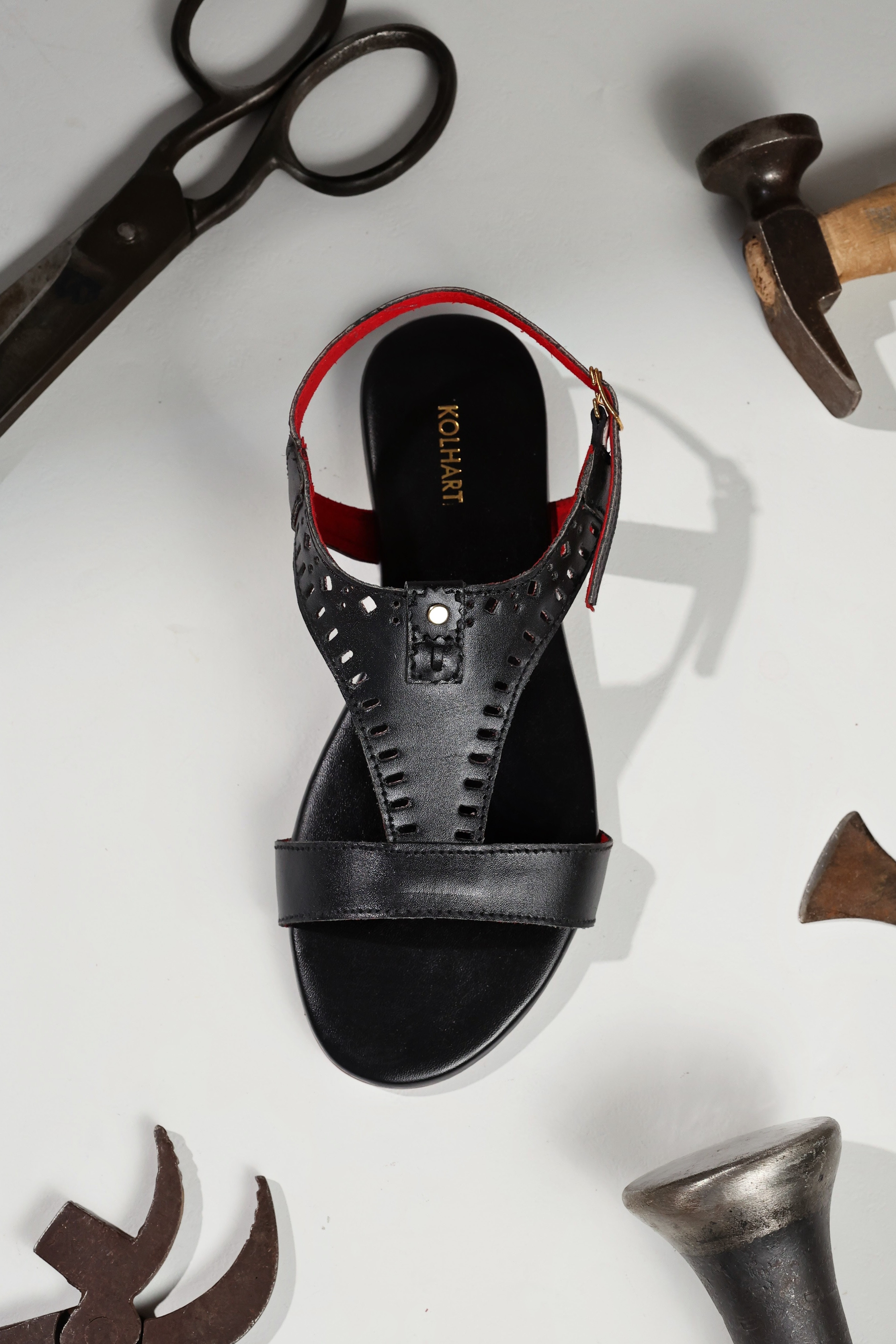 Black leather sandal with perforated design shown from top view